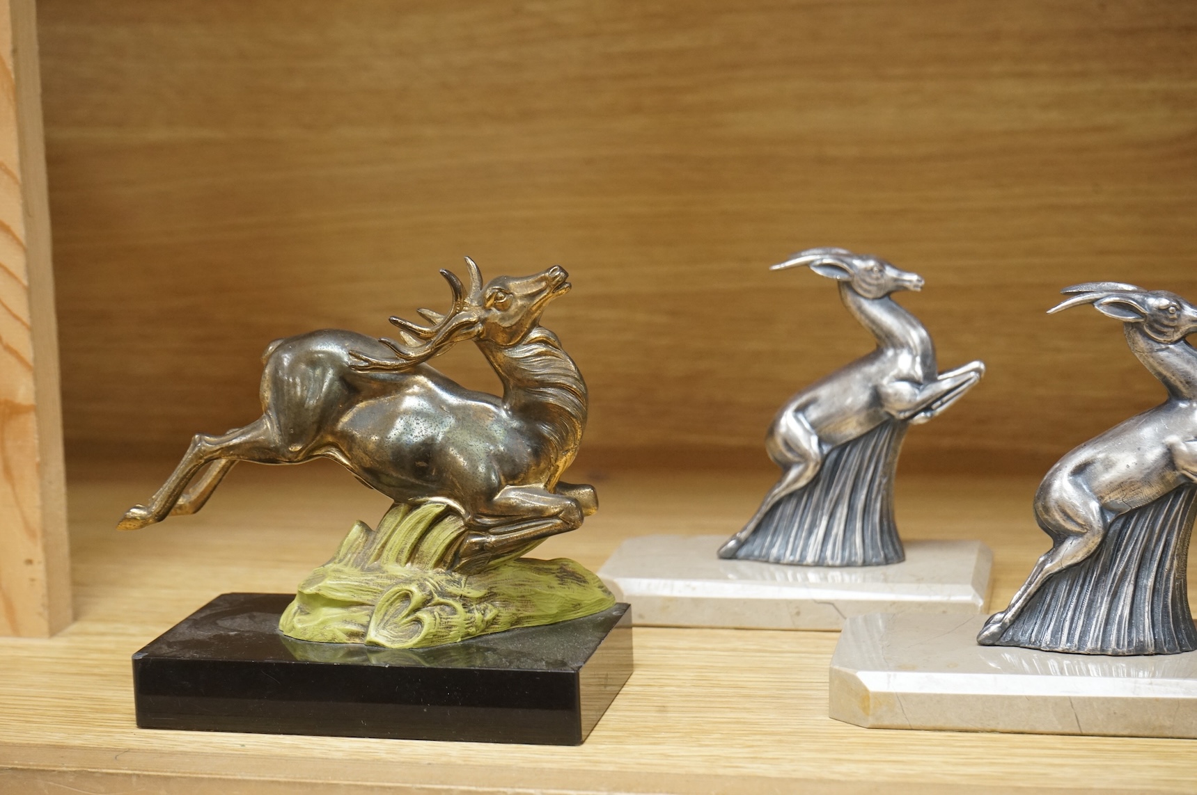 Two pairs of Art Deco bookends in the form of leaping animals, largest 14cm wide